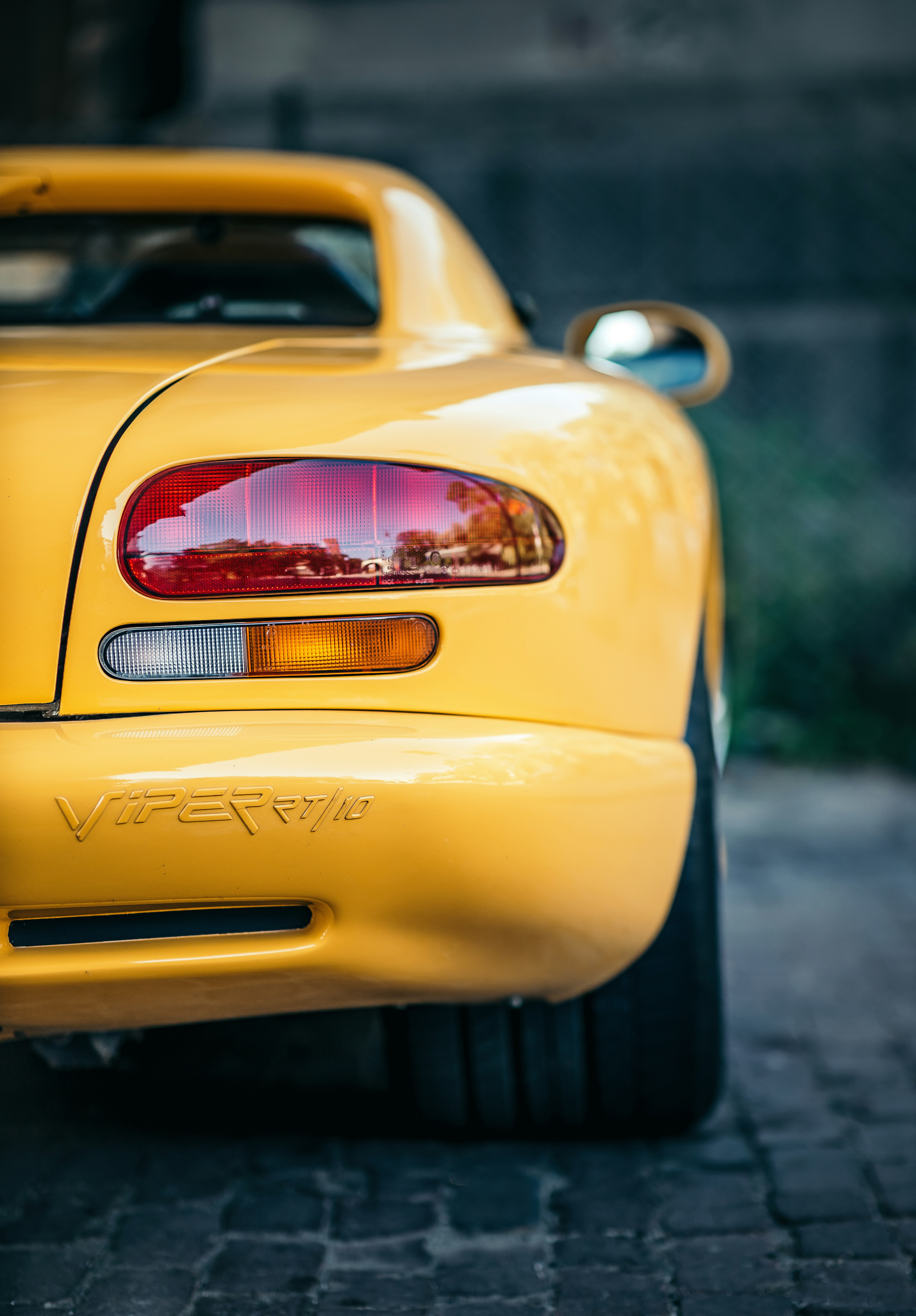 yellow car with lights on during daytime